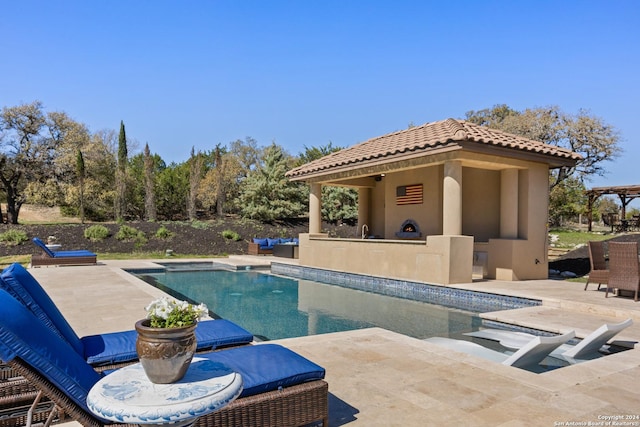 view of swimming pool featuring a patio and a fireplace