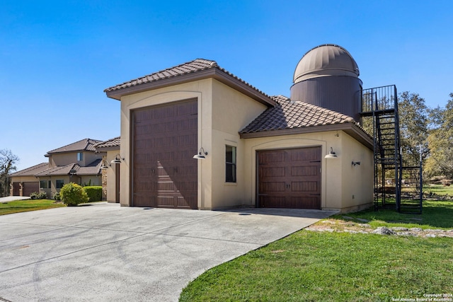 view of side of home featuring a garage and a yard