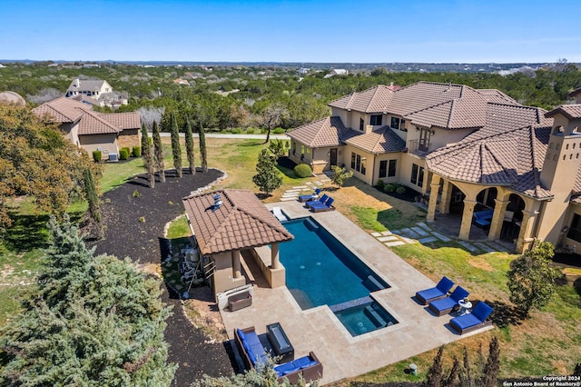 view of pool featuring an in ground hot tub, an outdoor hangout area, and a patio area