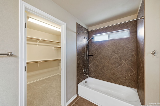 bathroom featuring tiled shower / bath and tile patterned flooring