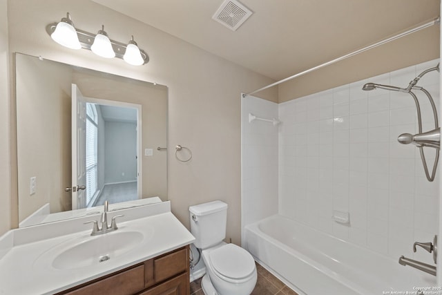 full bathroom with tiled shower / bath combo, vanity, and toilet