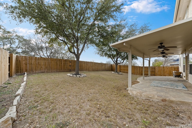 view of yard featuring a patio and ceiling fan