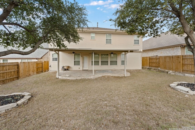 rear view of property featuring ceiling fan and a patio area