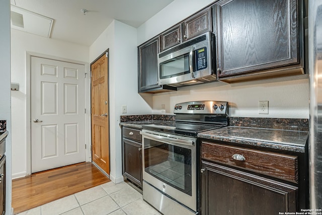 kitchen with light tile patterned flooring, appliances with stainless steel finishes, and dark brown cabinets