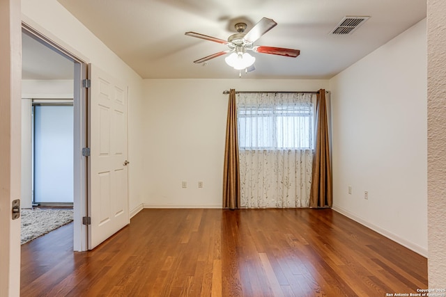 unfurnished room featuring dark hardwood / wood-style floors and ceiling fan