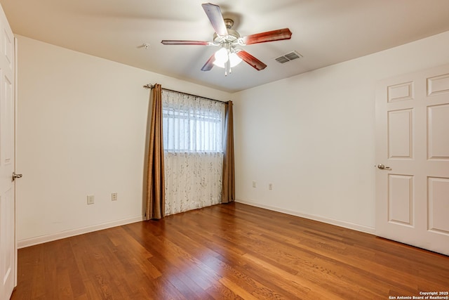 spare room with ceiling fan and wood-type flooring