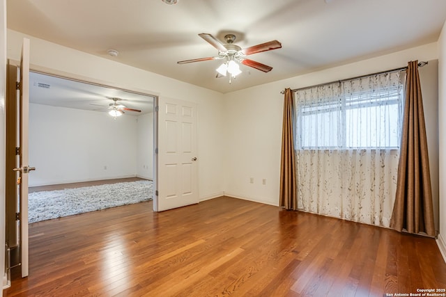 empty room featuring wood-type flooring and ceiling fan