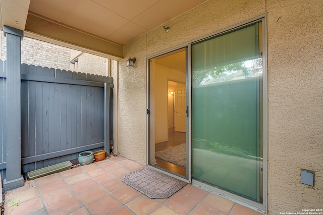 property entrance featuring a patio area