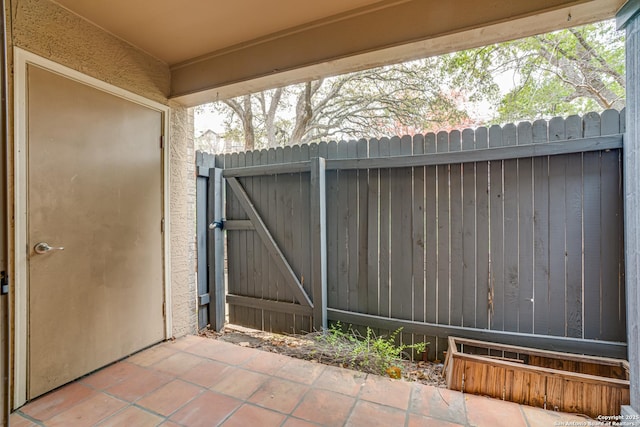 view of gate with a patio area