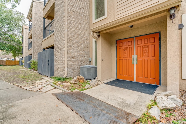 doorway to property featuring central AC unit