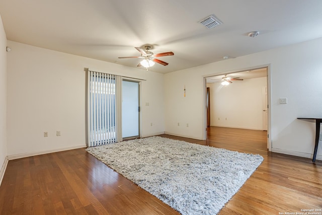 unfurnished room with hardwood / wood-style flooring and ceiling fan