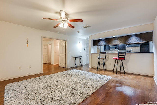 interior space featuring wood-type flooring and ceiling fan