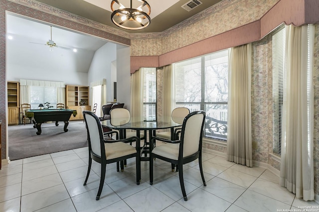 tiled dining space with ceiling fan with notable chandelier, billiards, and a towering ceiling