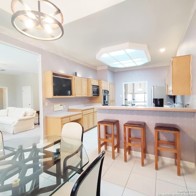 kitchen with appliances with stainless steel finishes, a breakfast bar, ornamental molding, kitchen peninsula, and light brown cabinets