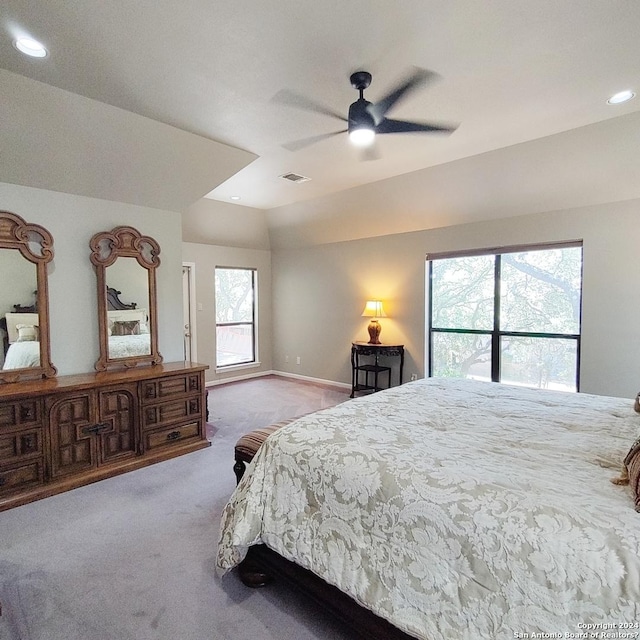 carpeted bedroom featuring ceiling fan and vaulted ceiling