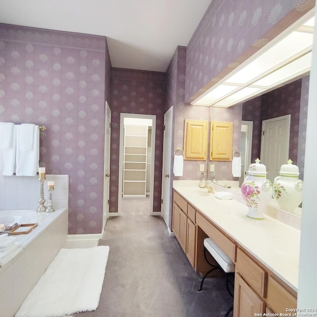 bathroom with vanity and a tub to relax in