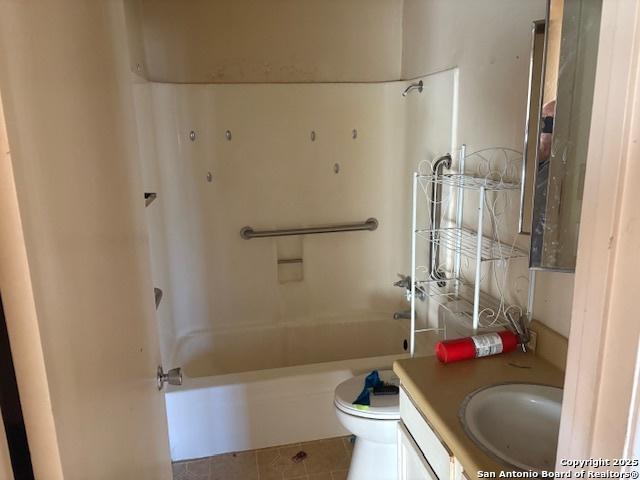 full bathroom featuring vanity, tile patterned flooring, shower / washtub combination, and toilet