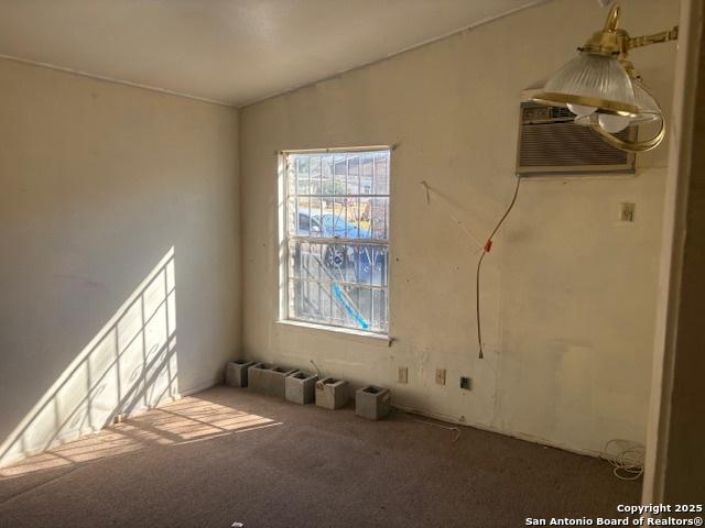 empty room featuring carpet and a wall unit AC