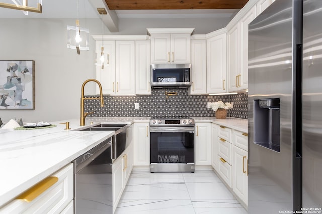 kitchen with appliances with stainless steel finishes, light stone counters, tasteful backsplash, white cabinets, and decorative light fixtures