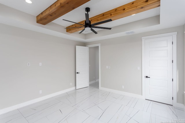 spare room featuring ceiling fan, a tray ceiling, and beam ceiling