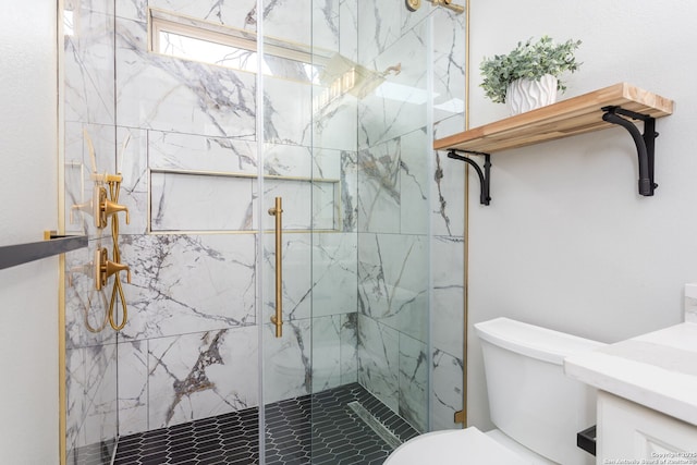 bathroom featuring a shower with door and toilet