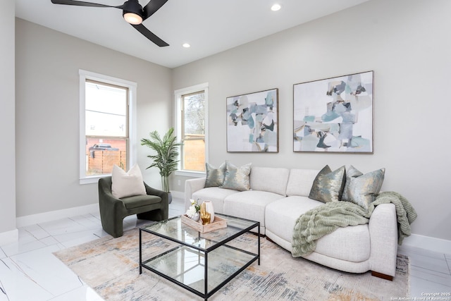 living room featuring ceiling fan and a wealth of natural light