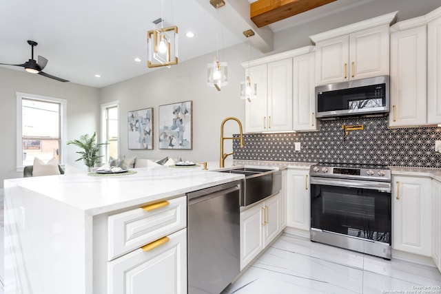 kitchen with white cabinetry, backsplash, pendant lighting, and stainless steel appliances