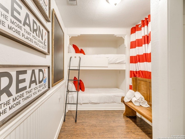 337 W Hackberry St, Fredericksburg, TX 78624 - bedroom with hardwood / wood-style floors and a textured ceiling