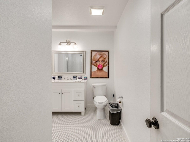 337 W Hackberry St, Fredericksburg, TX 78624 - bathroom with vanity, tile patterned flooring, and toilet