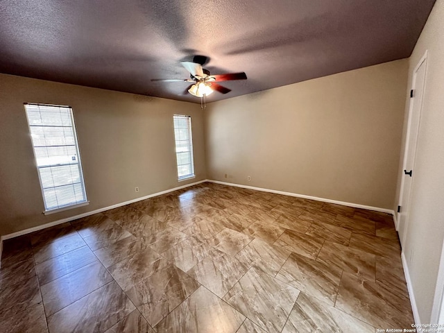 unfurnished room featuring a textured ceiling and ceiling fan