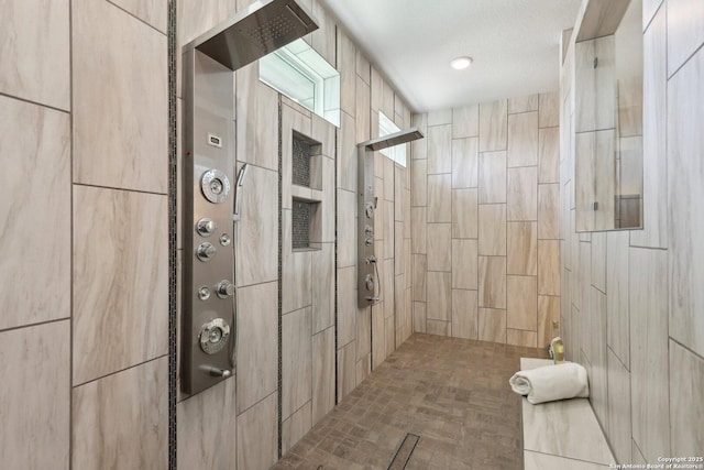 bathroom with a tile shower