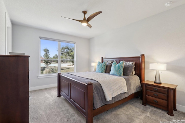 bedroom with ceiling fan and light colored carpet