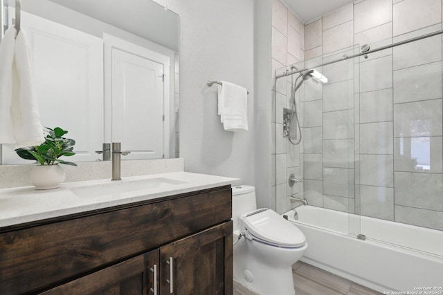 full bathroom featuring vanity, enclosed tub / shower combo, and toilet