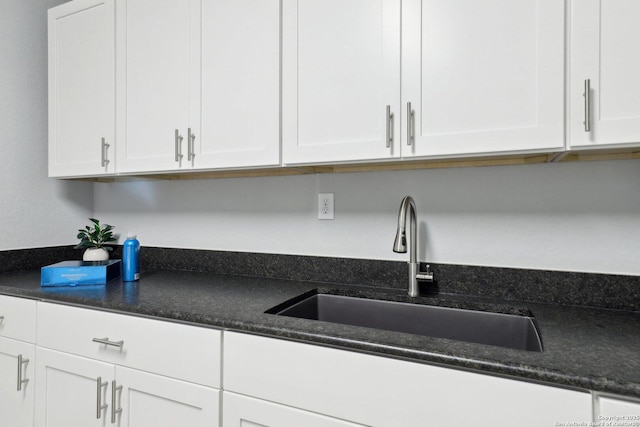 kitchen with white cabinetry and sink