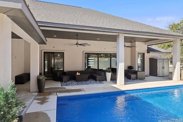 view of swimming pool featuring ceiling fan, an outdoor living space, and a patio