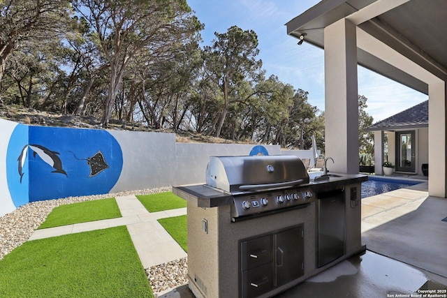 view of patio with an outdoor kitchen and a grill