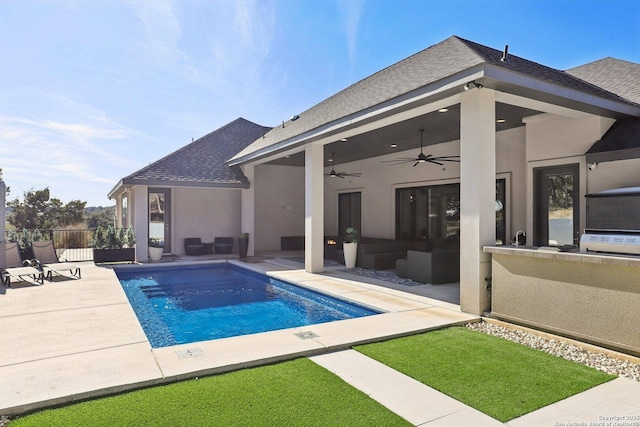 view of swimming pool with outdoor lounge area, ceiling fan, and a patio area