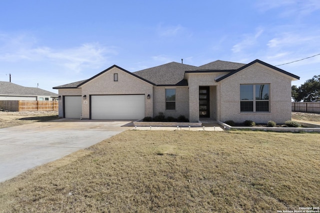 view of front of house featuring a garage and a front lawn