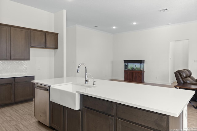 kitchen featuring tasteful backsplash, sink, stainless steel dishwasher, a center island with sink, and light hardwood / wood-style flooring