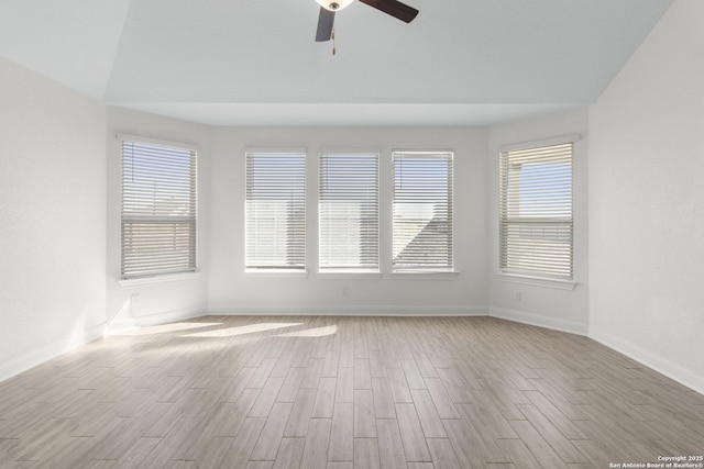 spare room with ceiling fan and light wood-type flooring