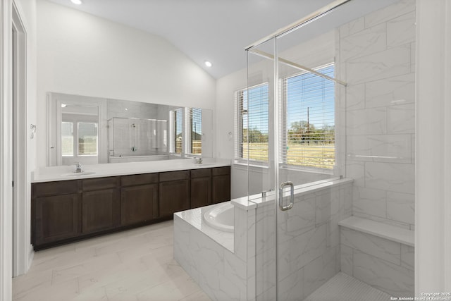 bathroom with vaulted ceiling, separate shower and tub, and vanity