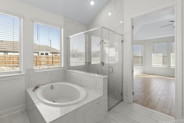 bathroom featuring lofted ceiling, shower with separate bathtub, and ceiling fan