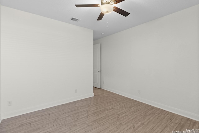 spare room featuring ceiling fan and light hardwood / wood-style flooring