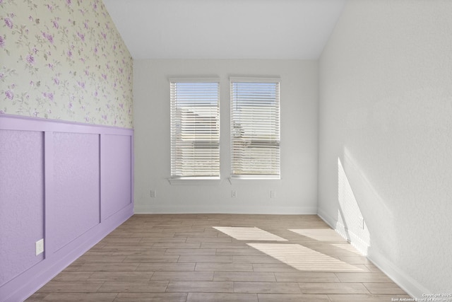 unfurnished room with lofted ceiling