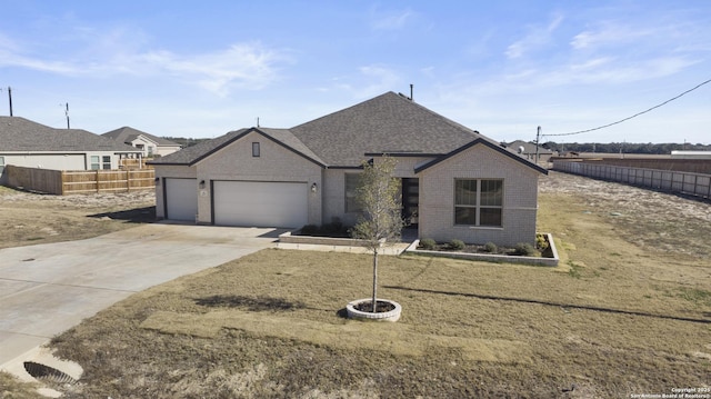 view of front of home with a garage and a front lawn