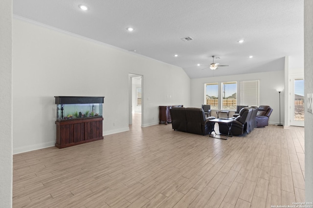 living room with lofted ceiling, crown molding, light hardwood / wood-style flooring, ceiling fan, and a textured ceiling