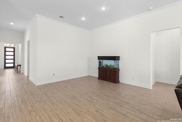 unfurnished living room featuring crown molding and light hardwood / wood-style floors