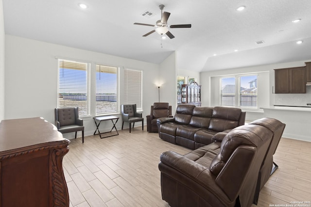 living room with vaulted ceiling, ceiling fan, and light hardwood / wood-style flooring