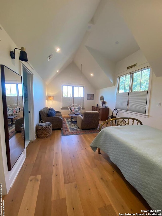 bedroom with lofted ceiling, visible vents, recessed lighting, and hardwood / wood-style flooring