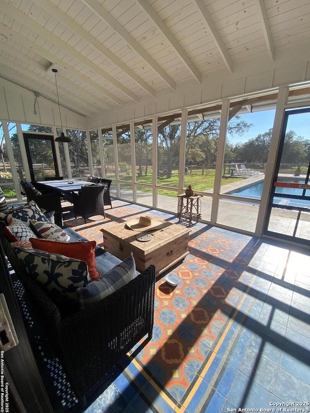 sunroom with wood ceiling and lofted ceiling with beams